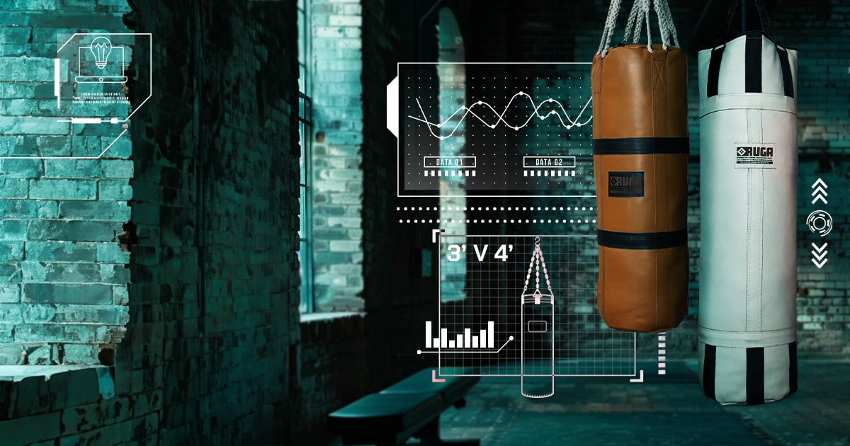 Two RUGA punching bags side by side in a gritty gym setting, one 3-foot and the other 4-foot, showcasing the difference in size and training potential.